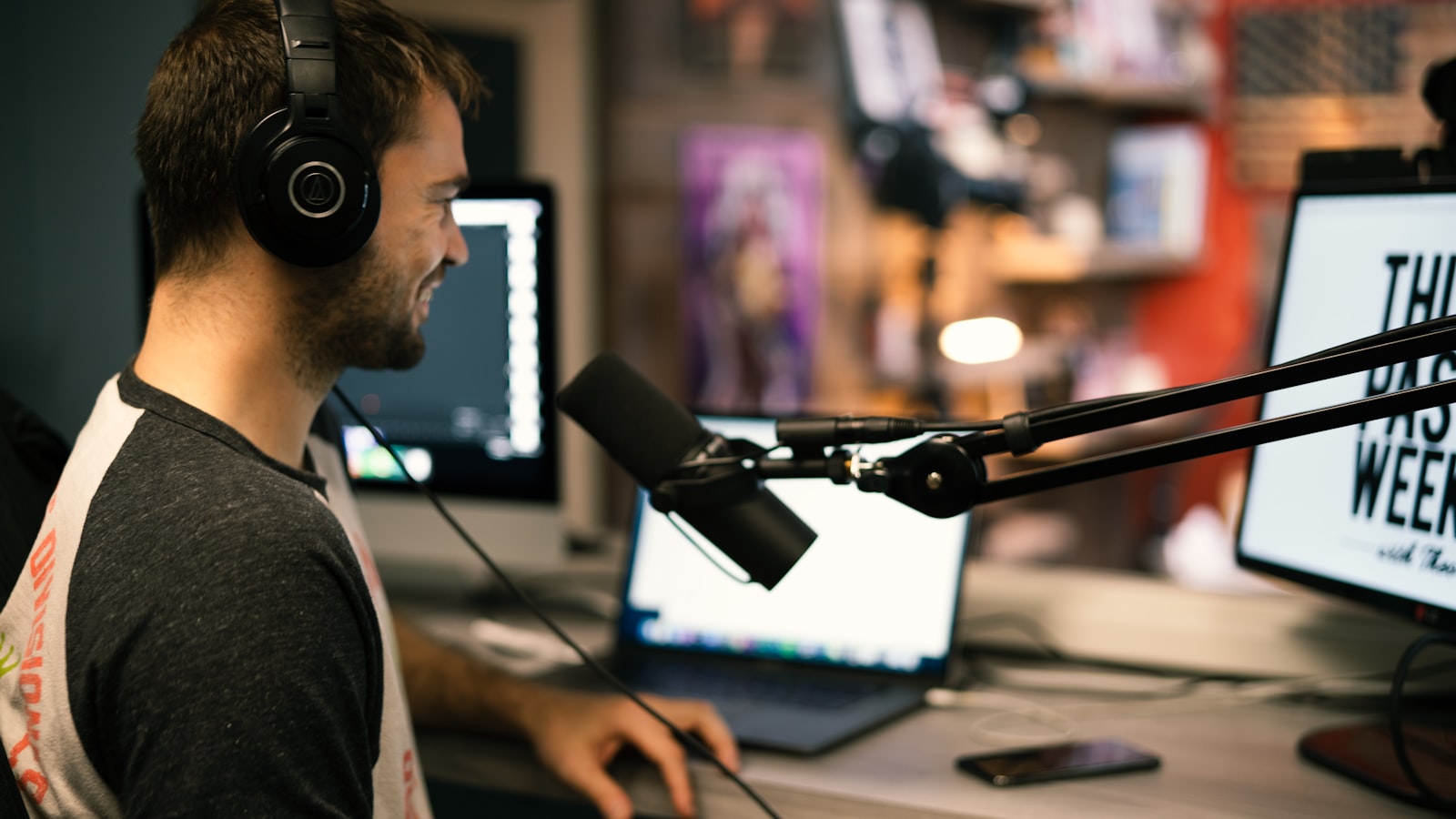 An independent broadcaster on air — headphones on, mic up, mid-show.